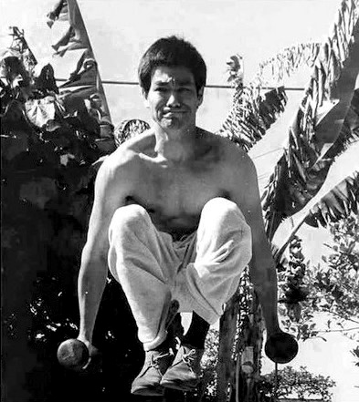 Bruce Lee power strength body muscles jumping with dumbbell weights