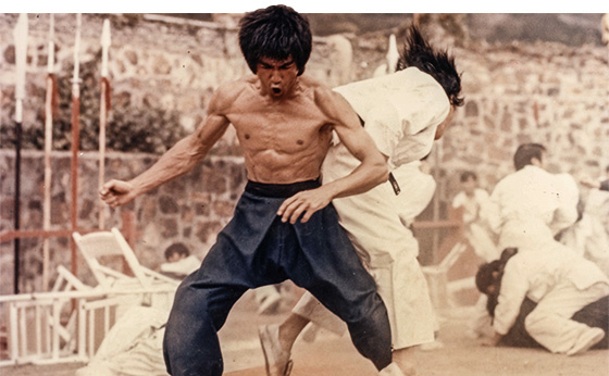 Bruce Lee Circuit Training kicking ass mid-punch Enter the Dragon